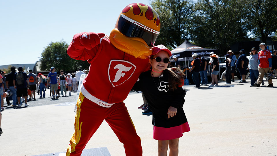 A child poses with Firehawk